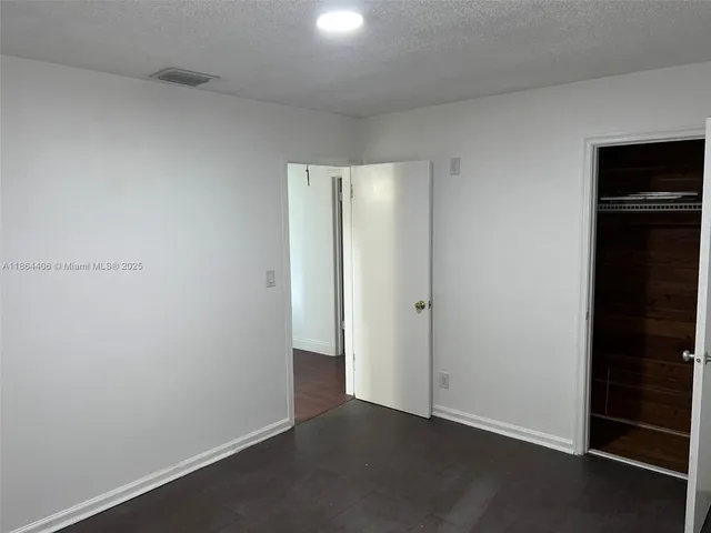 an empty room with closet area