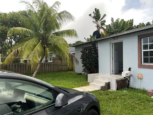 a view of backyard with swimming pool and outdoor seating