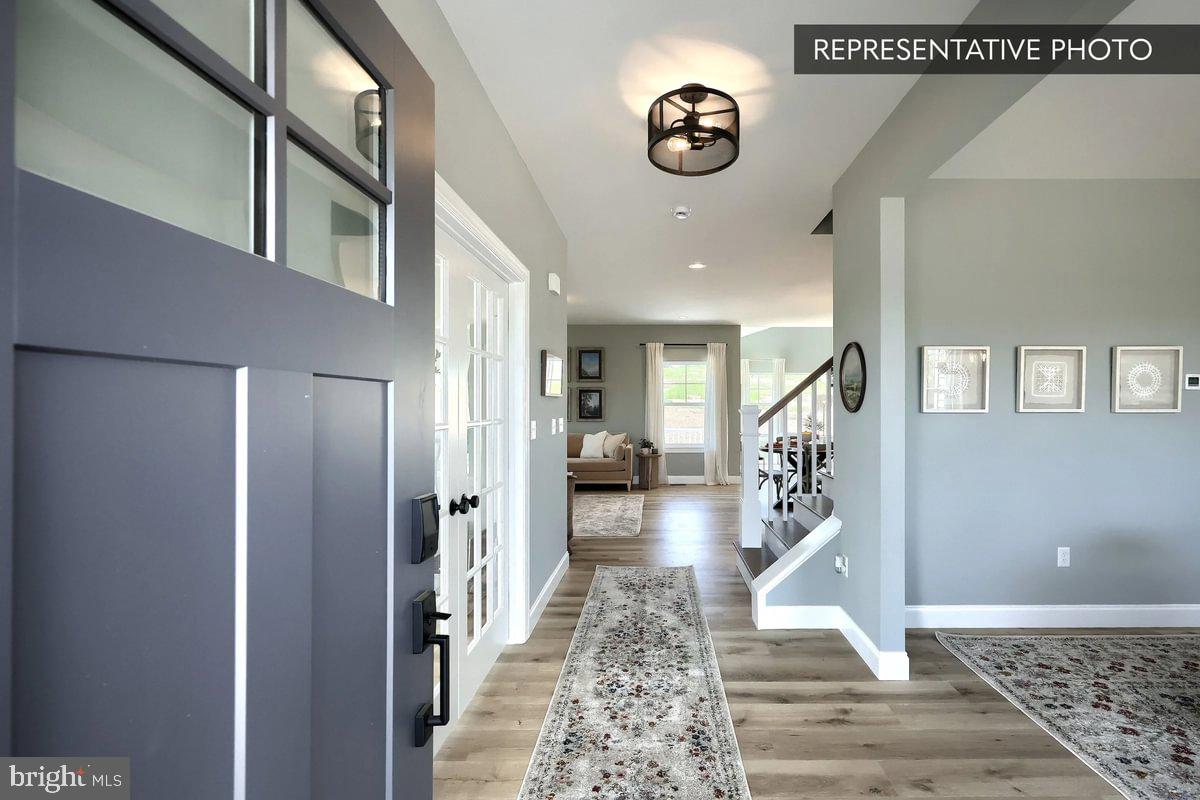 57 Sajer Road Pottsville, PA 17901 - Photo 2 of 22 a view of a hallway with wooden floor and a potted plant