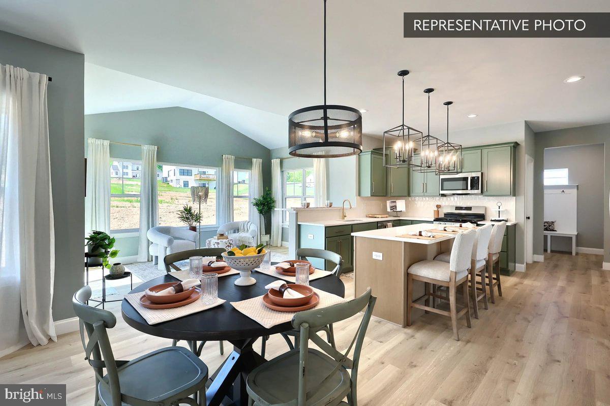 57 Sajer Road Pottsville, PA 17901 - Photo 9 of 22 a dining room with stainless steel appliances kitchen island a table and chairs in it