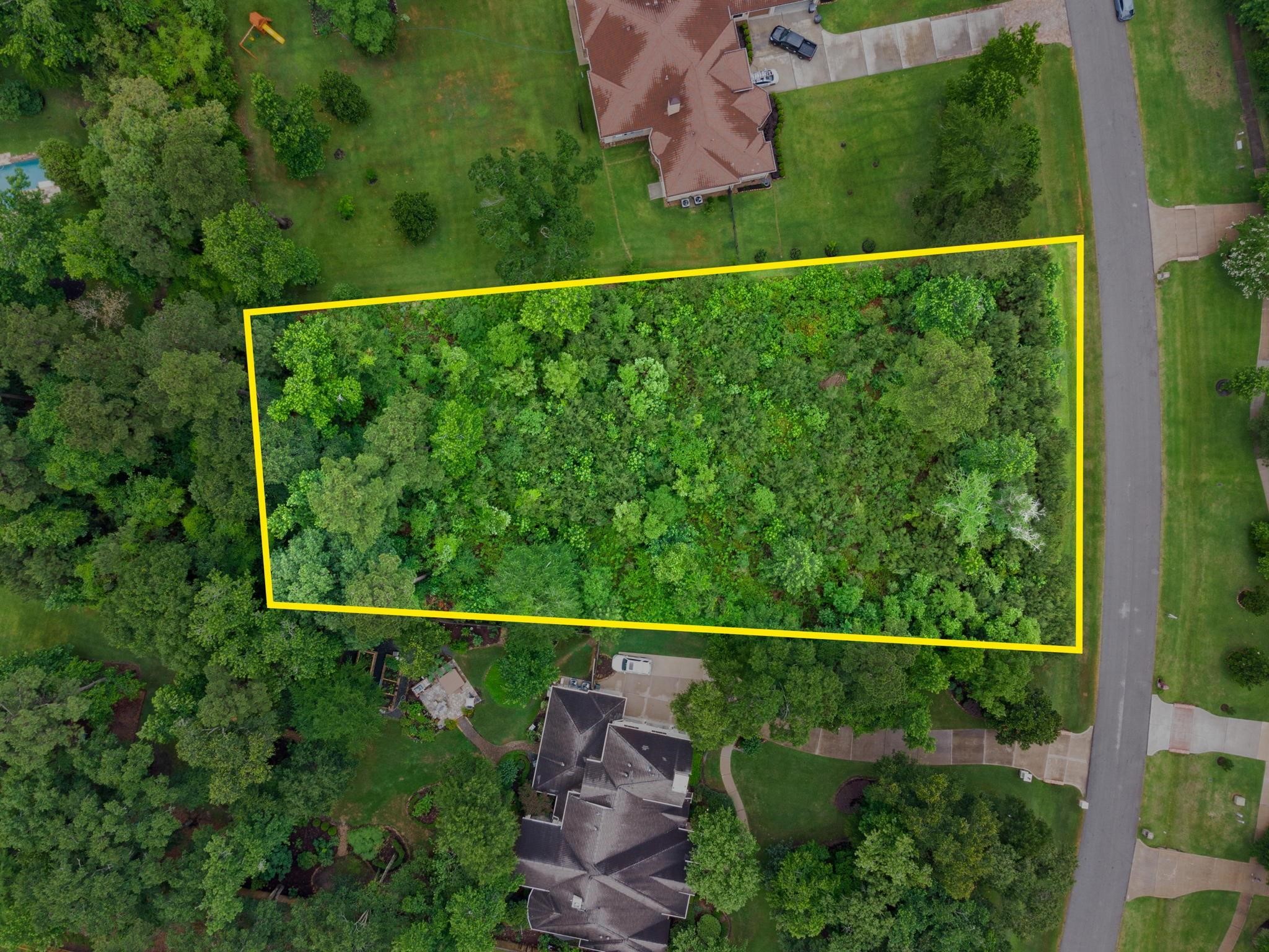 27403 Whispering Maple Way Spring, TX 77386 - Photo 6 of 10 Nestled in a suburban neighborhood, this rectangular, wooded lot offers the perfect blend of privacy and community access, with lush tree surroundings and convenient road adjacency.