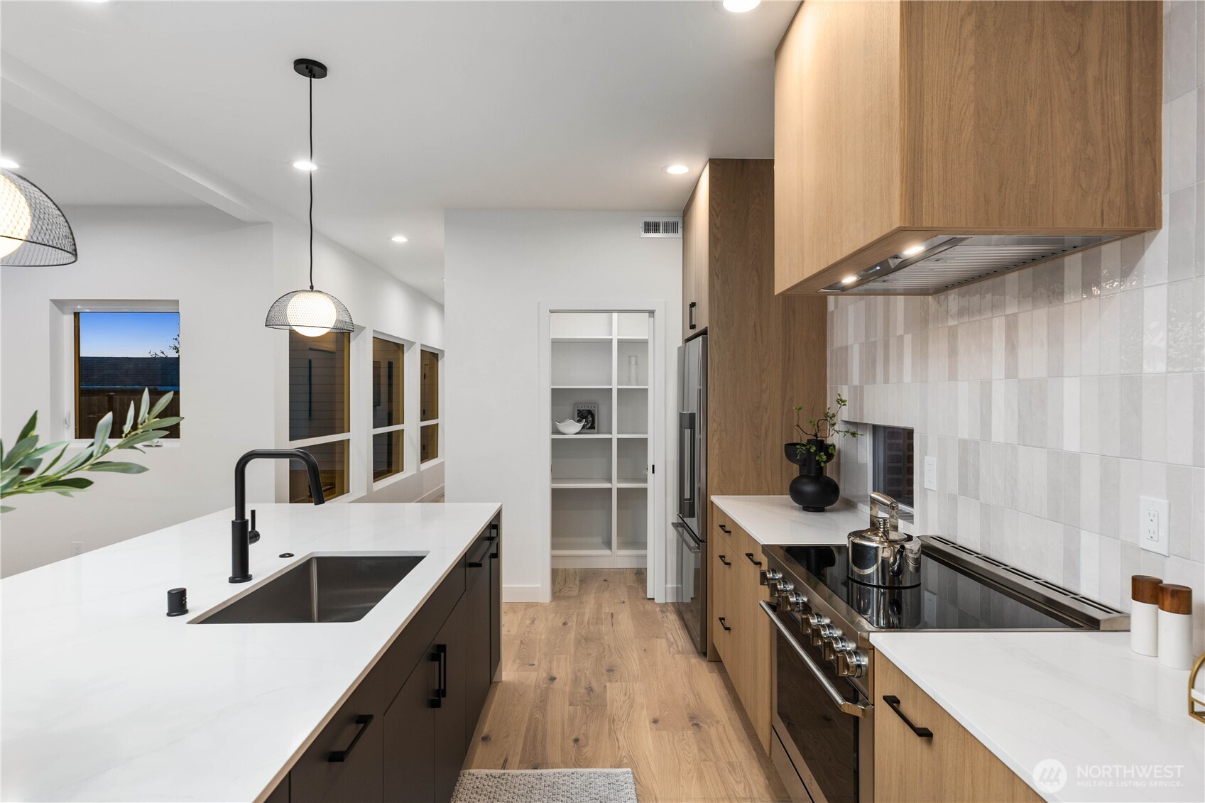 511 Morris Avenue South Renton, WA 98057 - Photo 12 of 40 a kitchen with counter top space a sink and stainless steel appliances