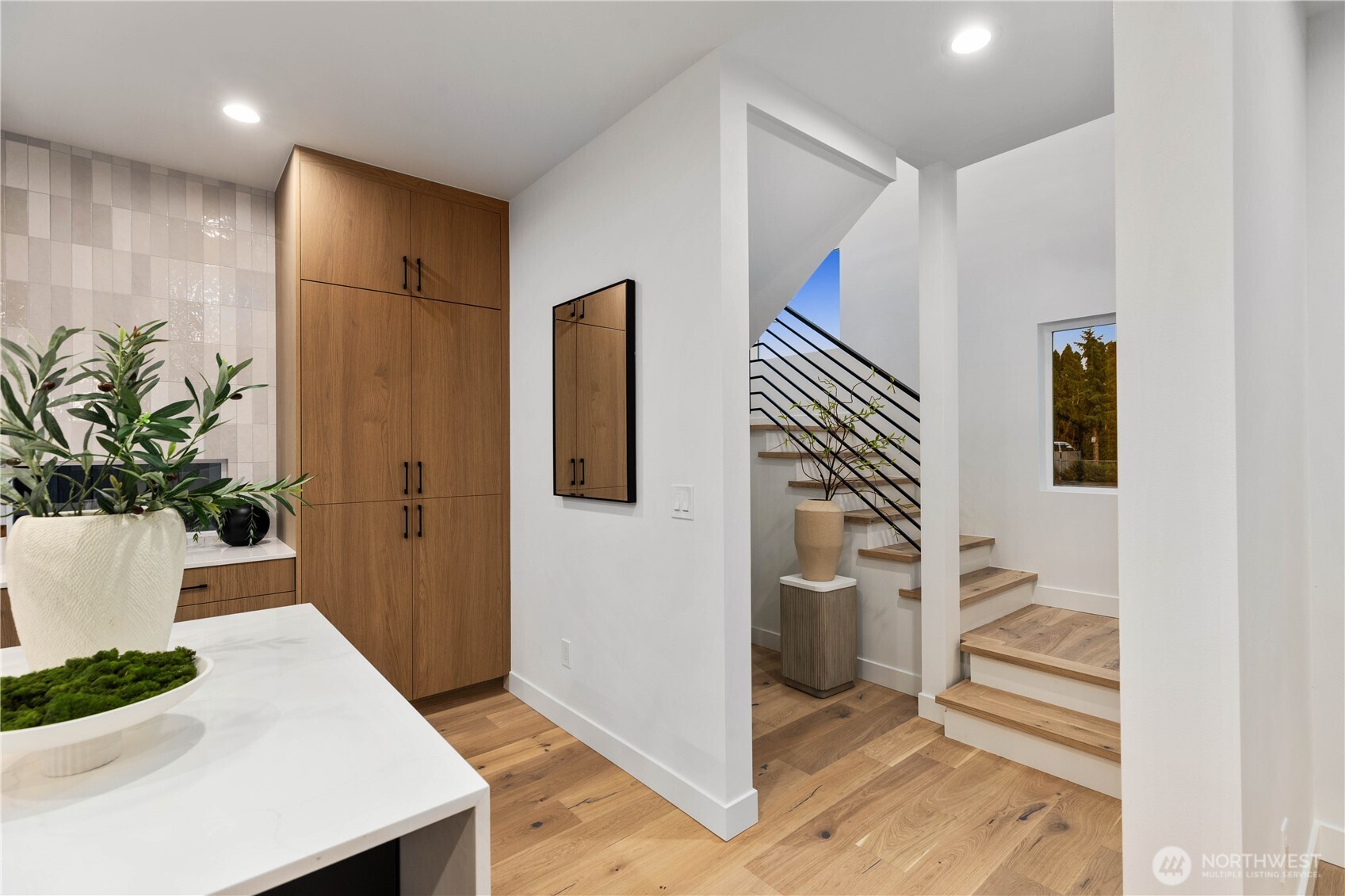 511 Morris Avenue South Renton, WA 98057 - Photo 15 of 40 a hallway with white cabinets and wooden floor
