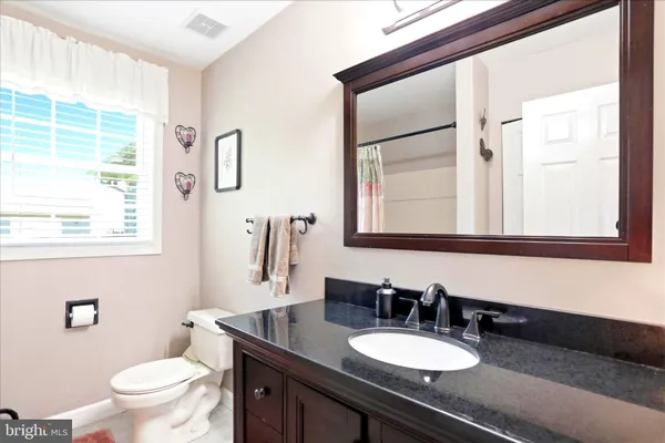 a bedroom with a bed a dresser and a window