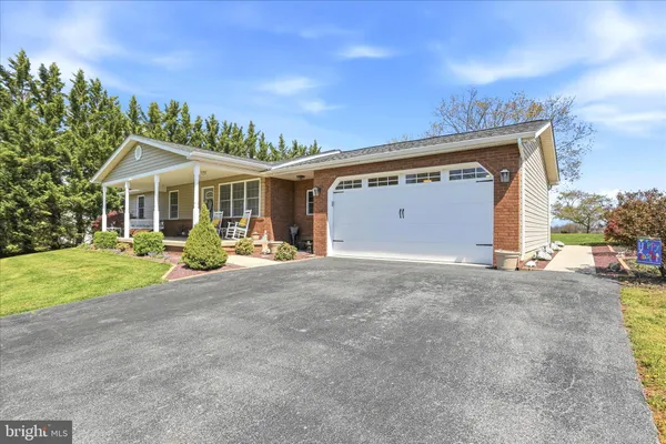 a front view of a house with yard and a garage