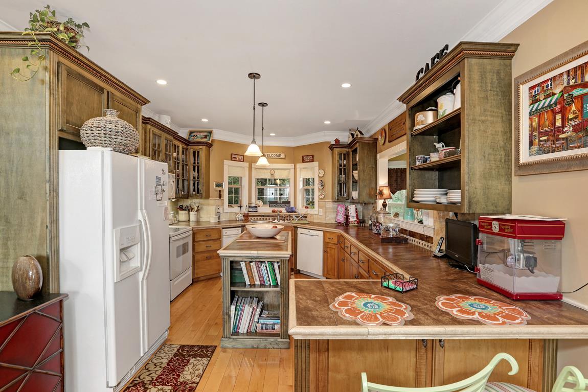 1690 Alf Harris Road Prospect, TN 38477 - Photo 14 of 30 a kitchen with stainless steel appliances kitchen island granite countertop a refrigerator and a stove top oven