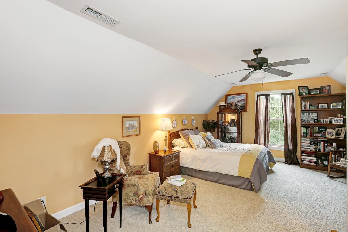 1690 Alf Harris Road Prospect, TN 38477 - Photo 27 of 30 a bedroom with a bed and a chandelier