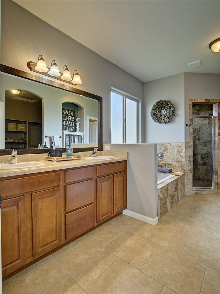 1171 Toscano Road Fruita, CO 81521 - Photo 14 of 27 a spacious bathroom with double vanity and a mirror