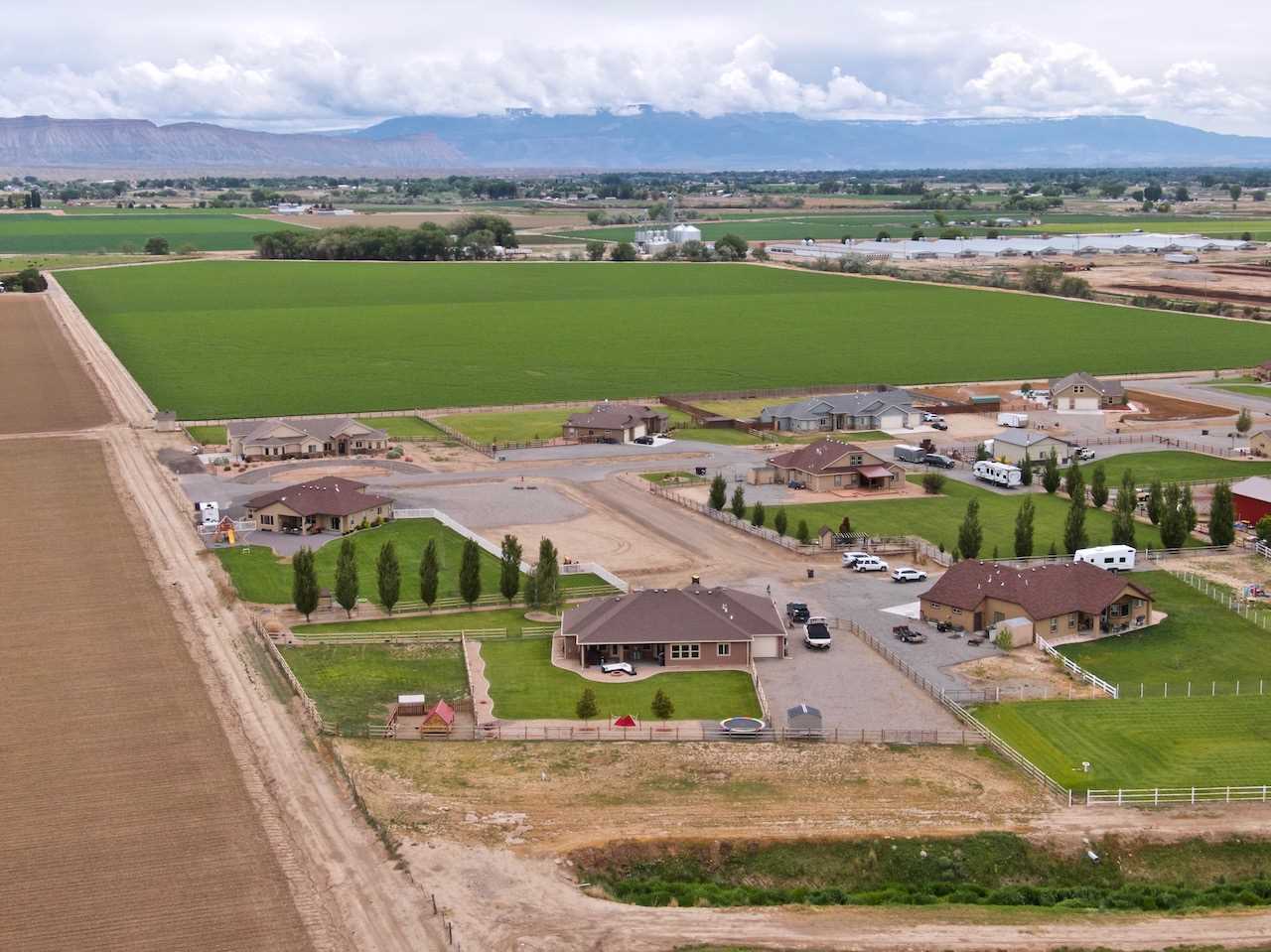 1171 Toscano Road Fruita, CO 81521 - Photo 27 of 27 an aerial view of a house with a garden and lake view