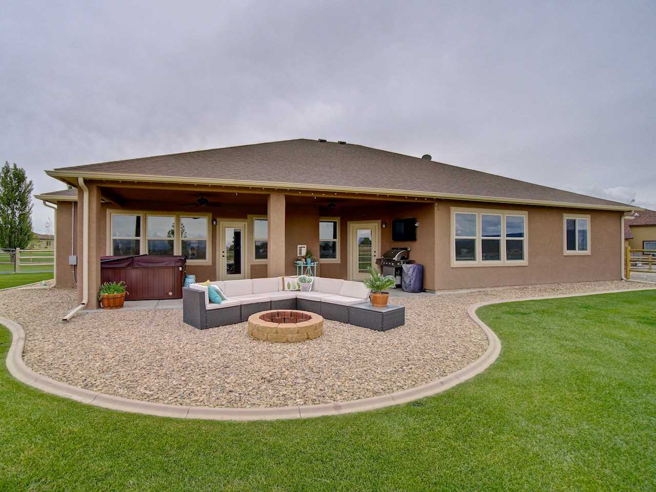 1171 Toscano Road Fruita, CO 81521 - Photo 3 of 27 a view of a house with backyard porch and sitting area