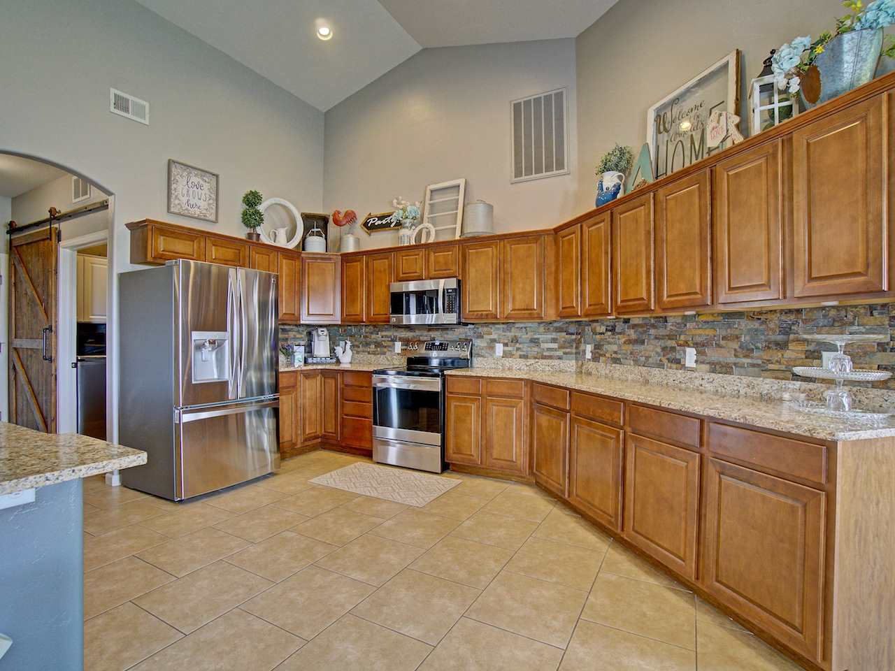1171 Toscano Road Fruita, CO 81521 - Photo 7 of 27 a kitchen with stainless steel appliances granite countertop a refrigerator sink and cabinets