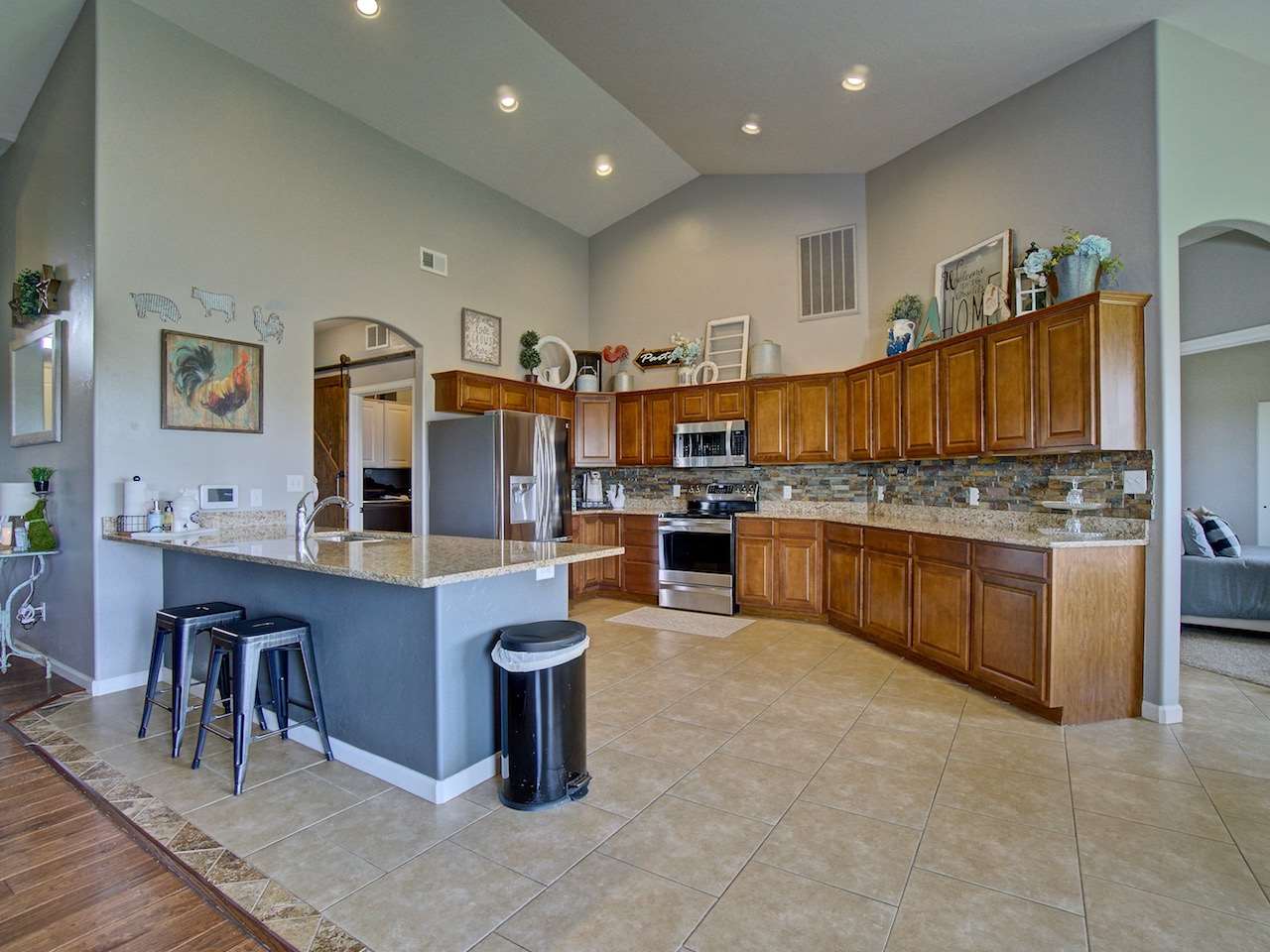 1171 Toscano Road Fruita, CO 81521 - Photo 8 of 27 a kitchen with stainless steel appliances kitchen island granite countertop a table chairs sink and cabinets