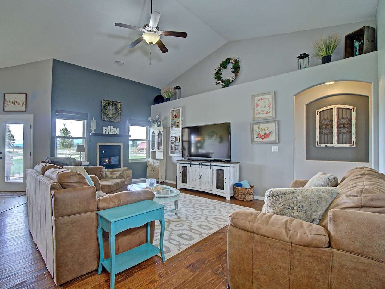 1171 Toscano Road Fruita, CO 81521 - Photo 10 of 27 a living room with furniture a fireplace and a flat screen tv