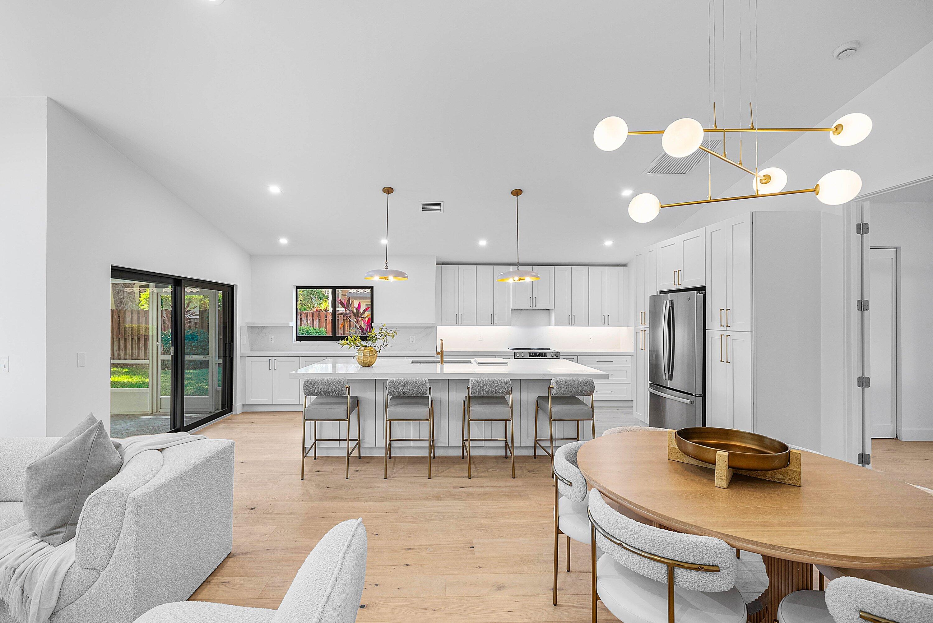 5723 Aspen Ridge Circle Delray Beach, FL 33484 - Photo 11 of 47 a living room with stainless steel appliances furniture a dining table and kitchen view