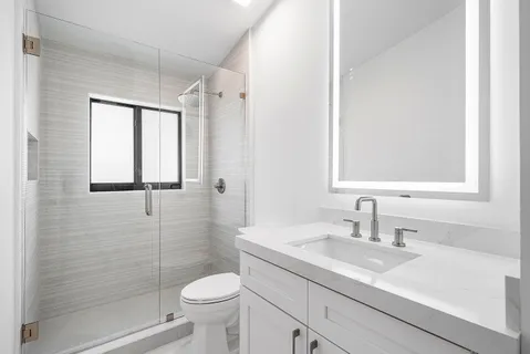 a living room with a bed furniture and a potted plant