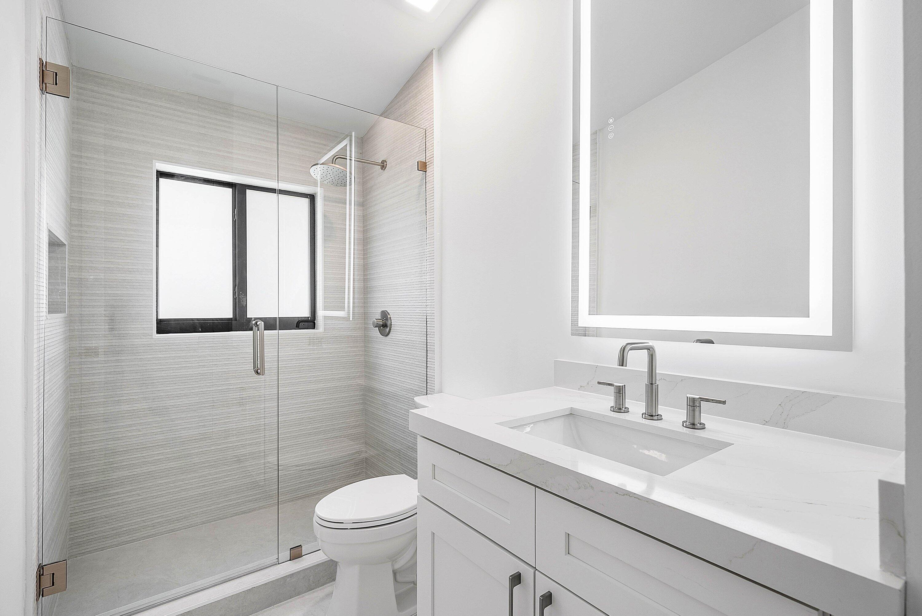 5723 Aspen Ridge Circle Delray Beach, FL 33484 - Photo 20 of 47 a bathroom with a sink a toilet and shower