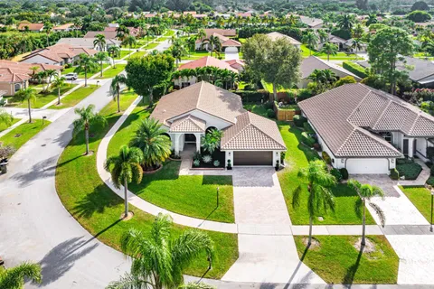an aerial view of residential houses with outdoor space and swimming pool