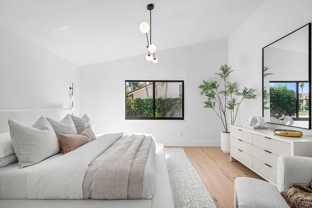 a large white bed in a white room