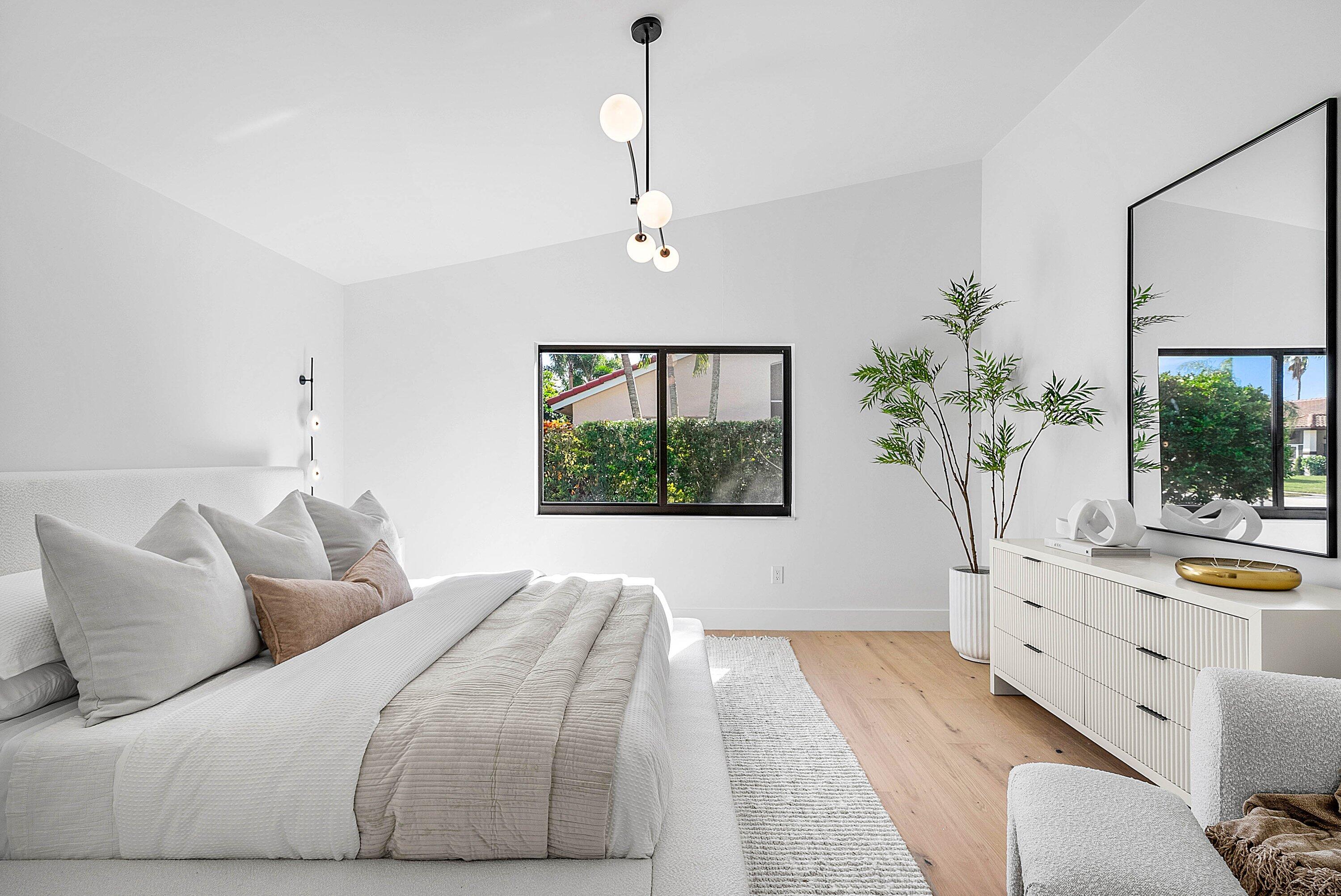 5723 Aspen Ridge Circle Delray Beach, FL 33484 - Photo 21 of 47 a living room with a bed furniture and a potted plant