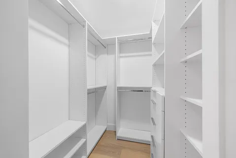 a spacious bathroom with a bathtub sink and mirror