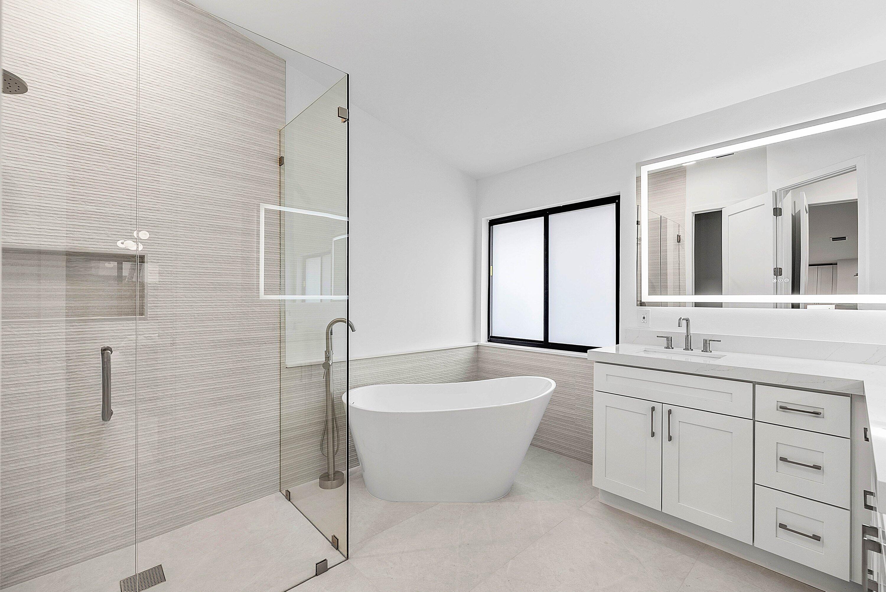 5723 Aspen Ridge Circle Delray Beach, FL 33484 - Photo 26 of 47 a spacious bathroom with a bathtub sink and mirror