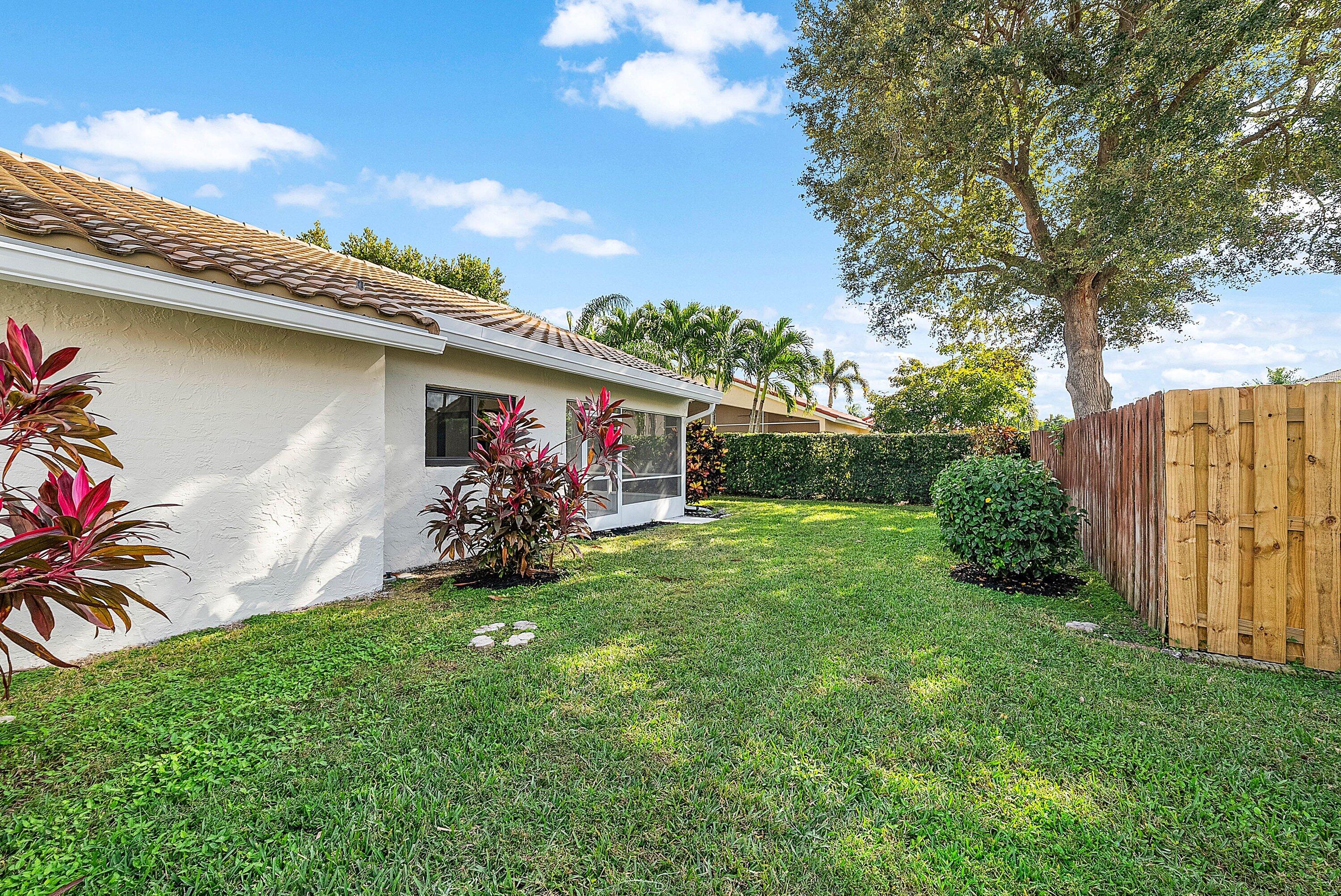 5723 Aspen Ridge Circle Delray Beach, FL 33484 - Photo 33 of 47 a view of a garden with a patio