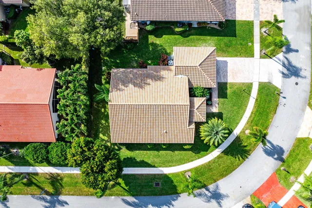 an aerial view of residential houses with outdoor space and street view