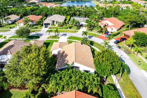 an aerial view of a house with a yard and outdoor seating