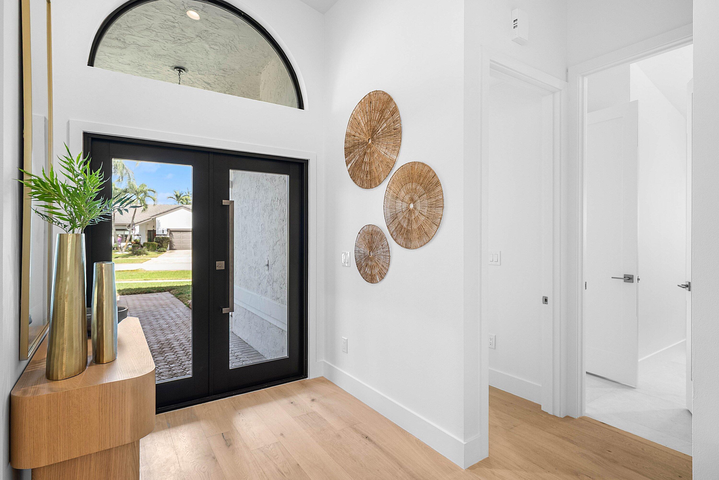 5723 Aspen Ridge Circle Delray Beach, FL 33484 - Photo 6 of 47 a view of a livingroom with wooden floor and a large window