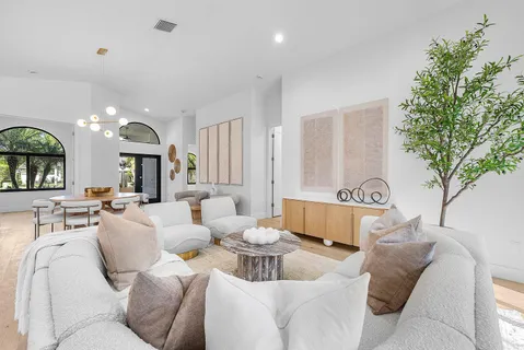 a living room with furniture and a large mirror