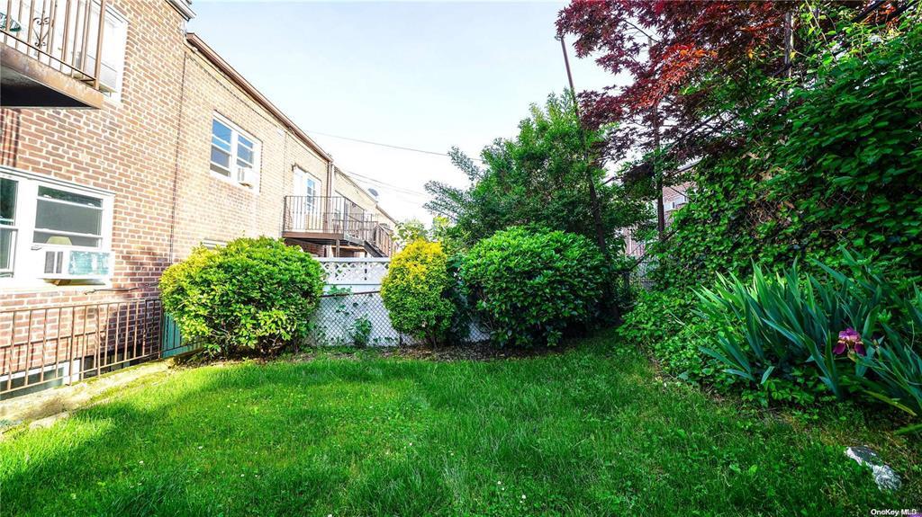 41-20 210th Street, Unit 1 Queens, NY 11361 - Photo 11 of 17 View of yard featuring fence