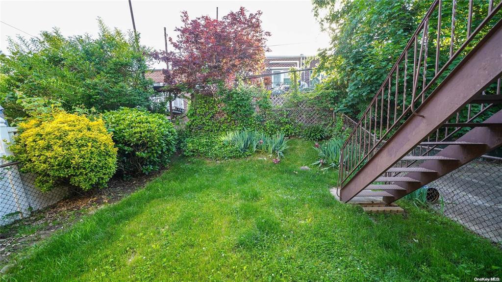 41-20 210th Street, Unit 1 Queens, NY 11361 - Photo 12 of 17 View of yard with stairs