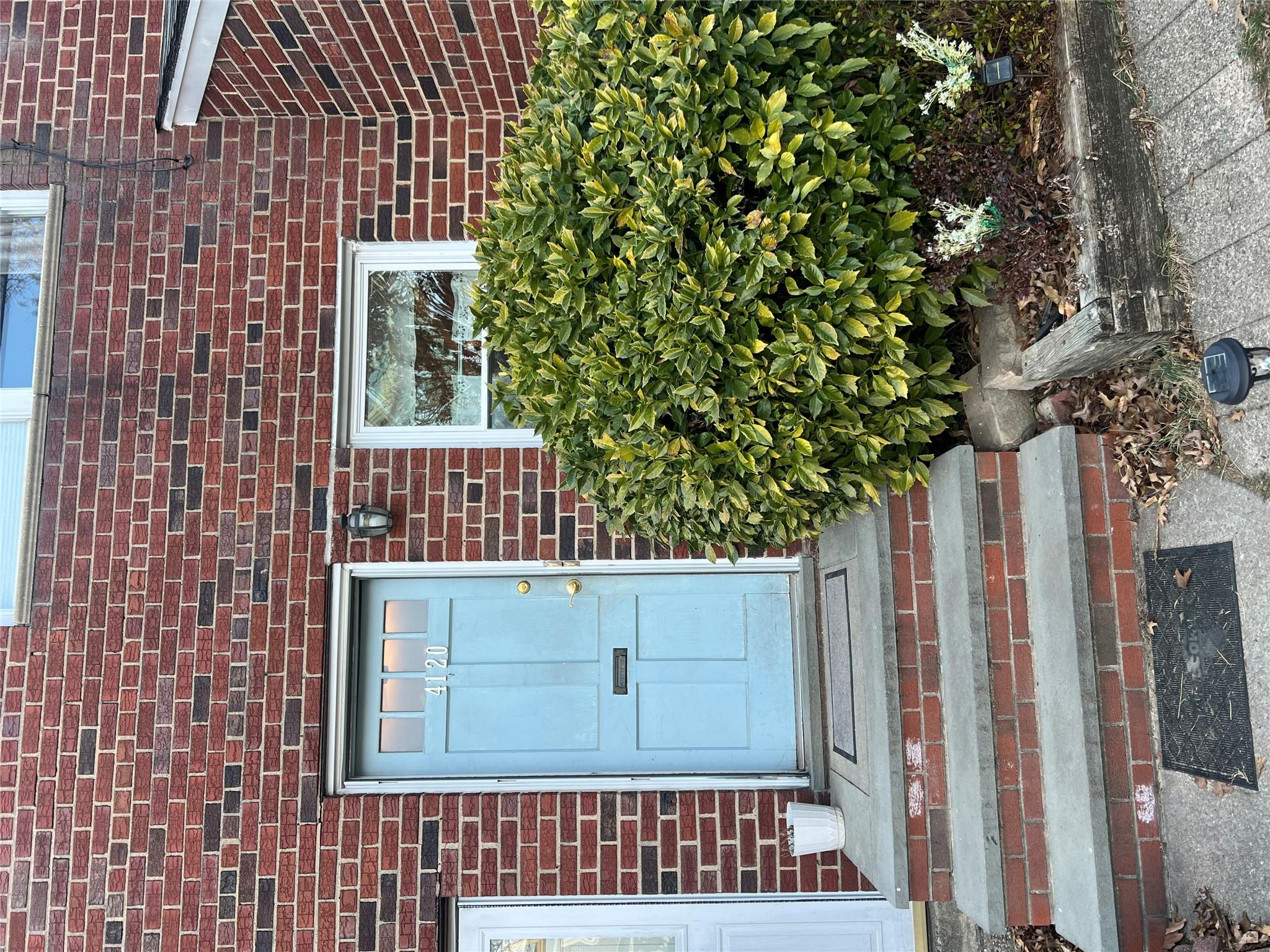 41-20 210th Street, Unit 1 Queens, NY 11361 - Photo 2 of 17 Doorway to property featuring brick siding