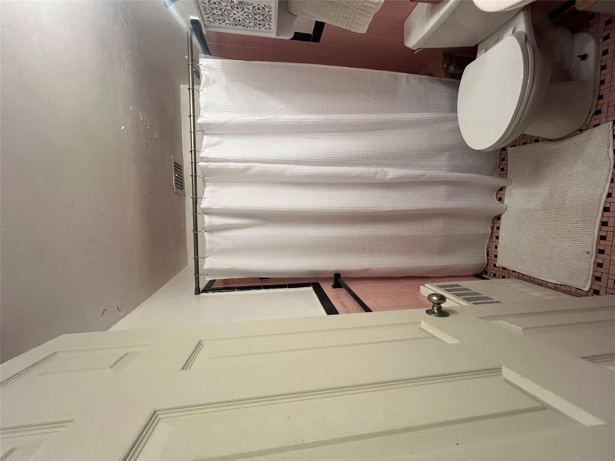 41-20 210th Street, Unit 1 Queens, NY 11361 - Photo 9 of 17 Bathroom featuring toilet, tile walls, curtained shower, and visible vents