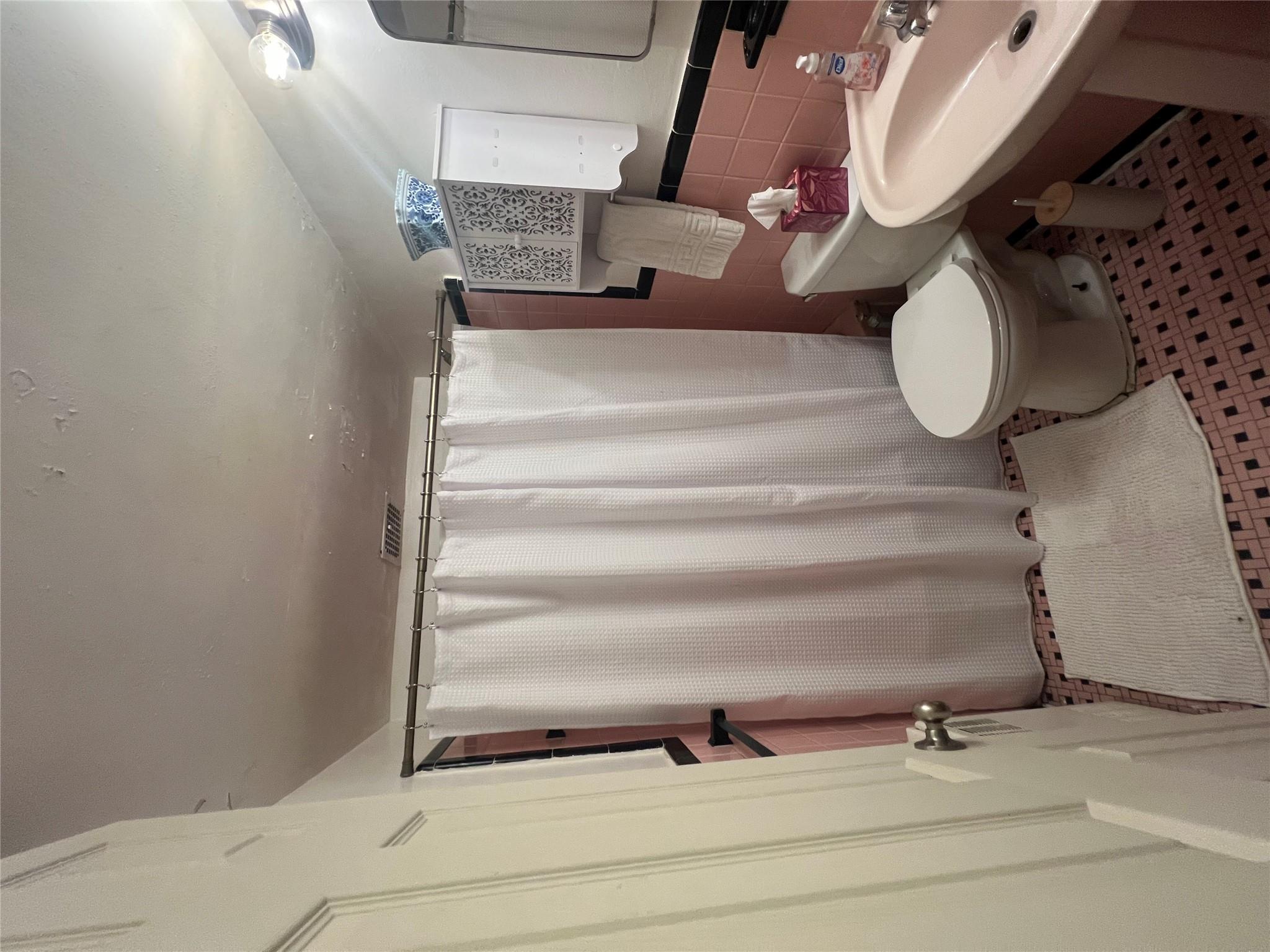 41-20 210th Street, Unit 1 Queens, NY 11361 - Photo 10 of 17 Full bathroom featuring toilet, visible vents, curtained shower, and tile walls