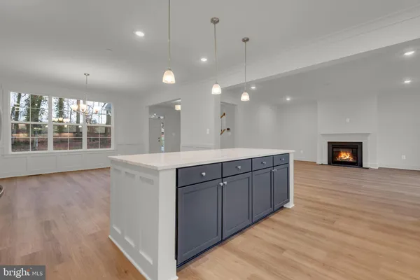 a kitchen with a sink cabinets and wooden floor