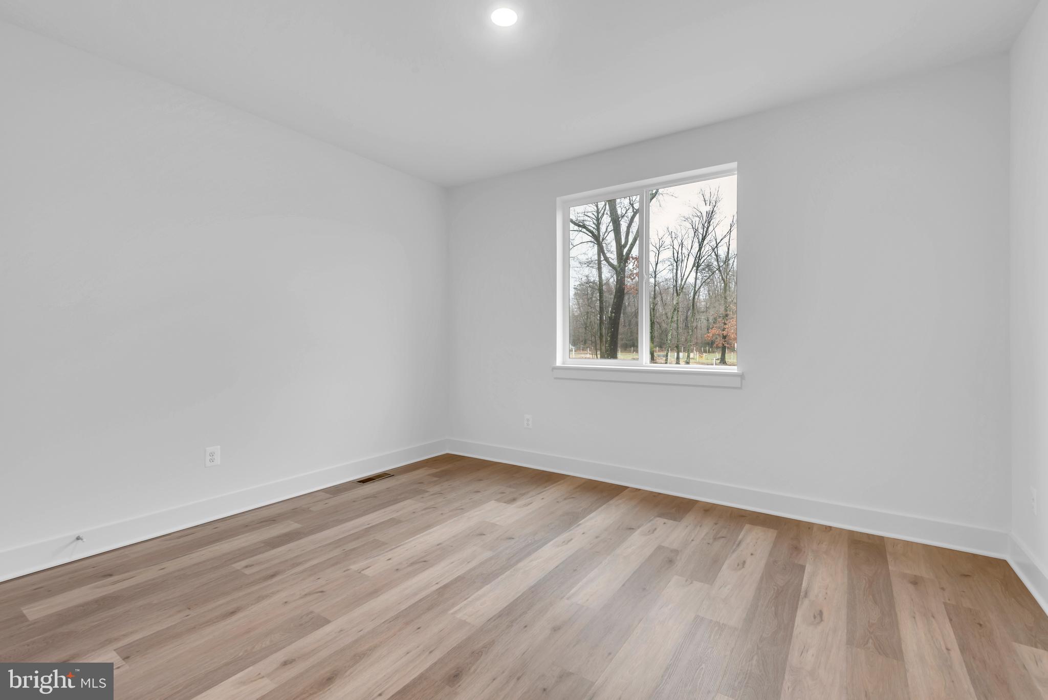 6502 Whitetail Xing Way Hanover, MD 21076 - Photo 20 of 54 wooden floor in an empty room with a window