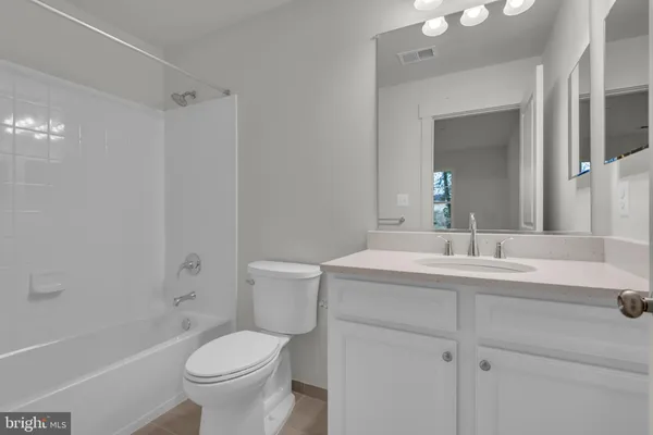 a view of a hallway with wooden floor and stairs