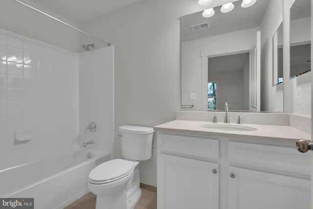 a spacious bathroom with a bathtub and shower