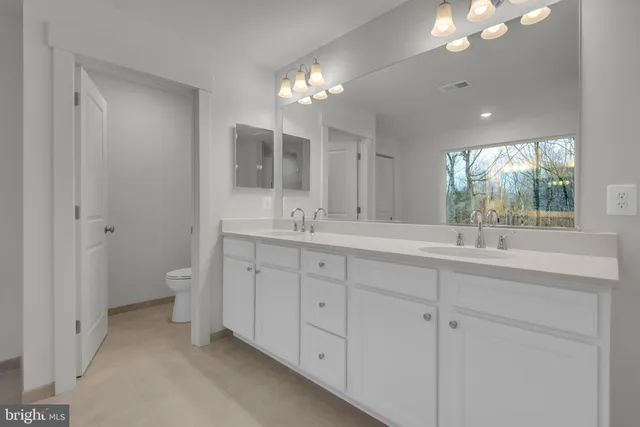 a view of a hallway with wooden floor and entryway