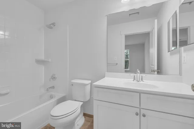 a bathroom with a sink toilet vanity tub and shower