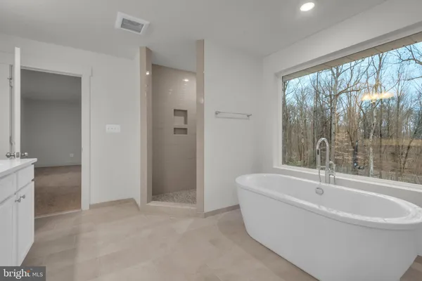 a view of a hallway with wooden floor and entryway
