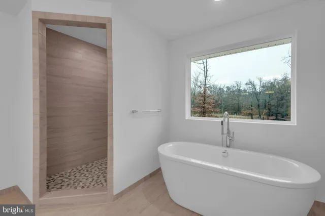 a white bath tub sitting next to a window
