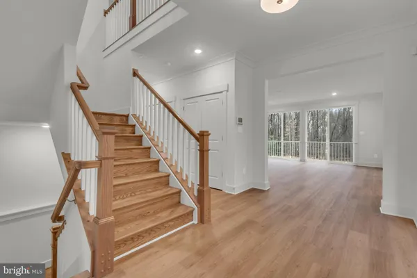 a view of entryway and hall with wooden floor