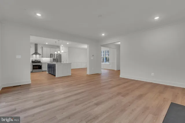 a kitchen with stainless steel appliances kitchen island granite countertop a stove and a sink