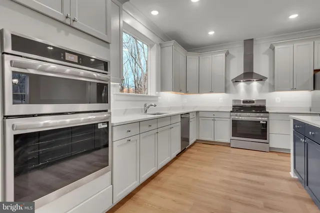 a kitchen with a stove top oven and sink