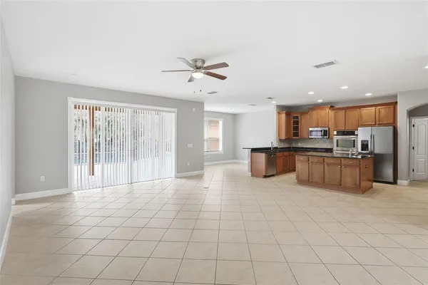 a large white kitchen with kitchen island granite countertop a large counter top and appliances