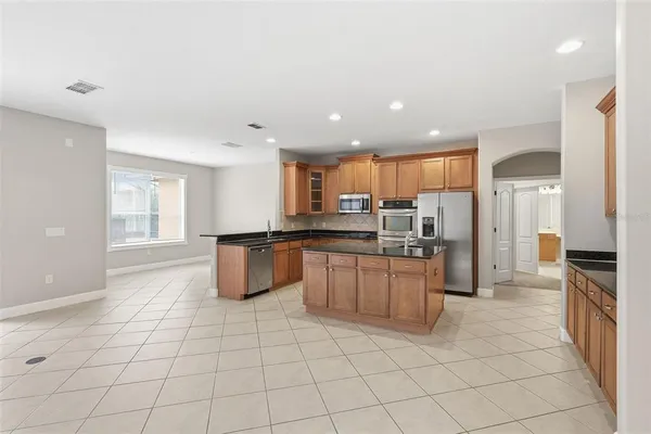 a kitchen with stainless steel appliances granite countertop a sink and cabinets