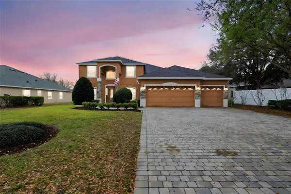 a front view of a house with a yard and garage