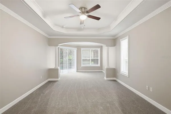 an empty room that has a window and a kitchen with sink